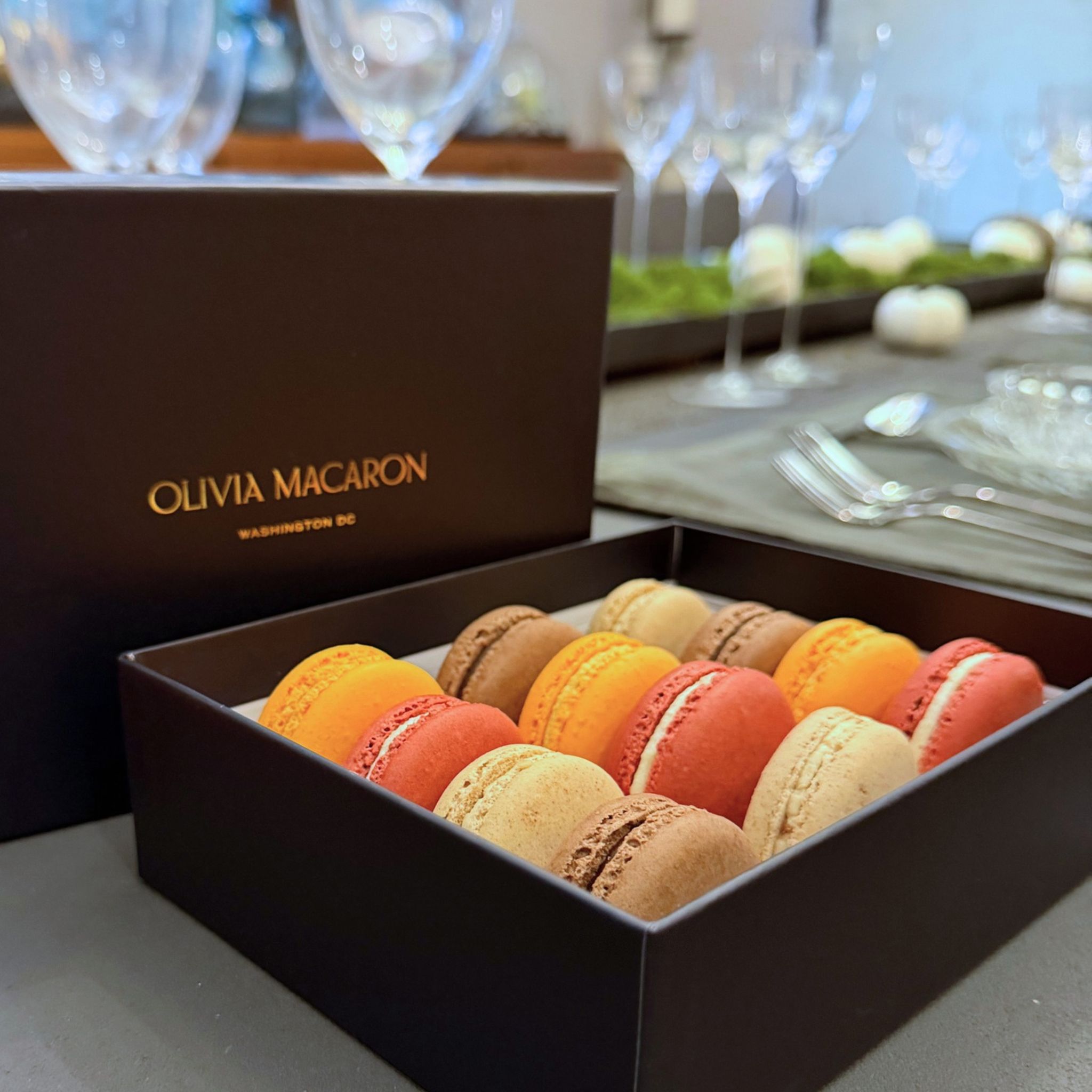 Thanksgiving macaron gift box on a holiday table with white pumpkins